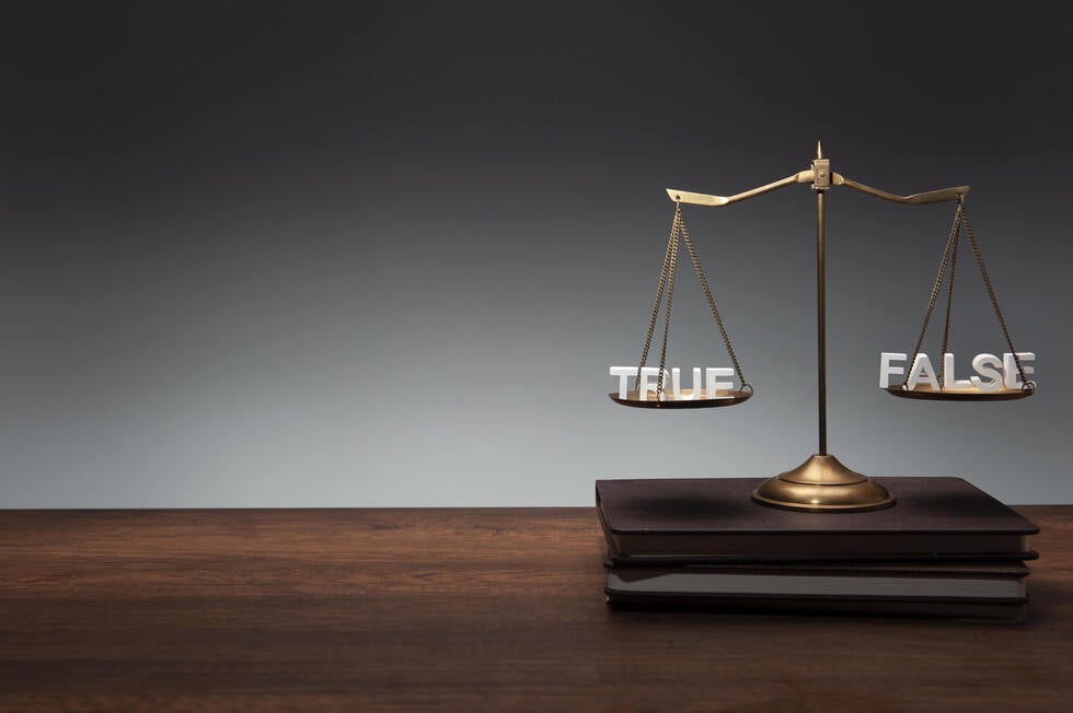 A defense attorney from Gallo Criminal Defense Las Vegas in Las Vegas, Nevada carefully reviewing documents and digital evidence to support a person falsely accused of a criminal offense.