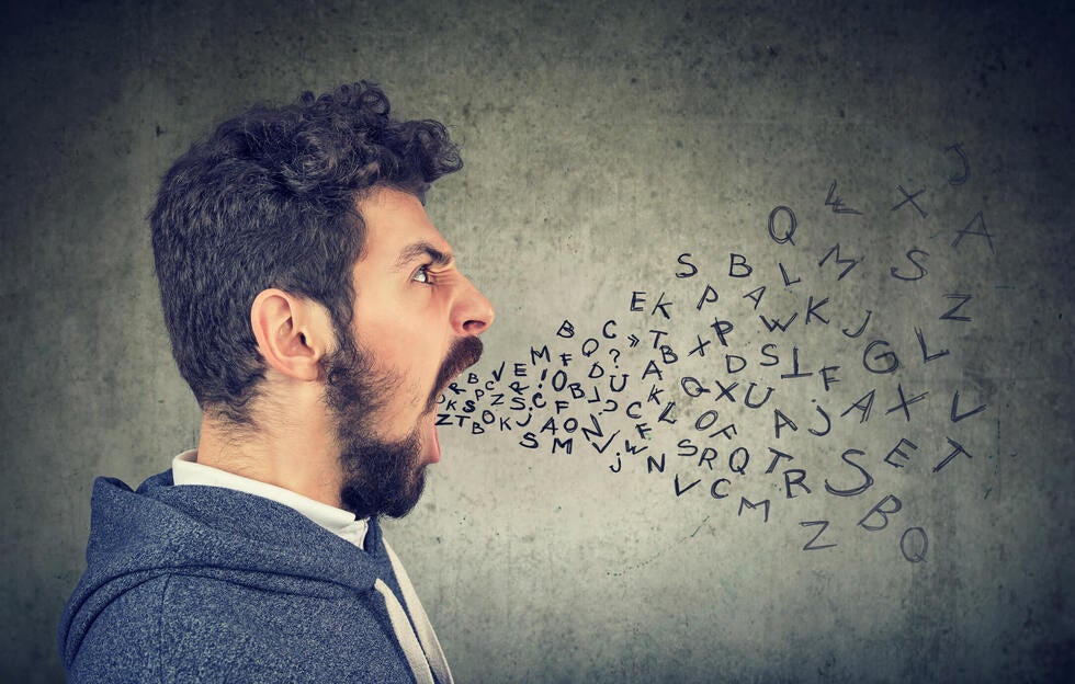 A specialized criminal defense lawyer in Las Vegas, Nevada, at Gallo Criminal Defense Las Vegas reviewing a legal report on verbal abuse and harassment statutes to prepare a strong defense for a client.
