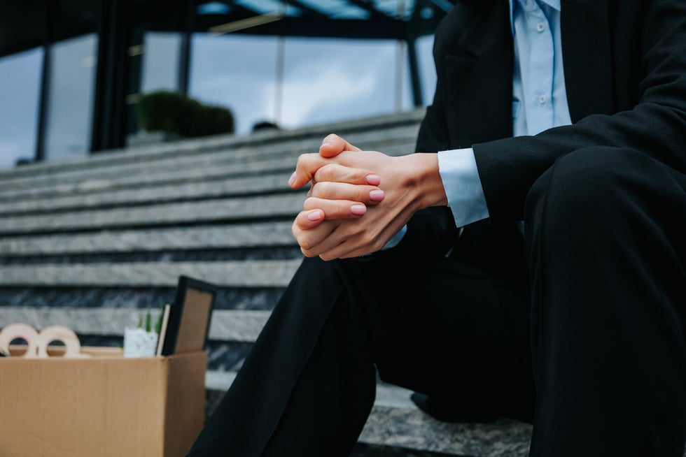 Unemployed worker in front of old office