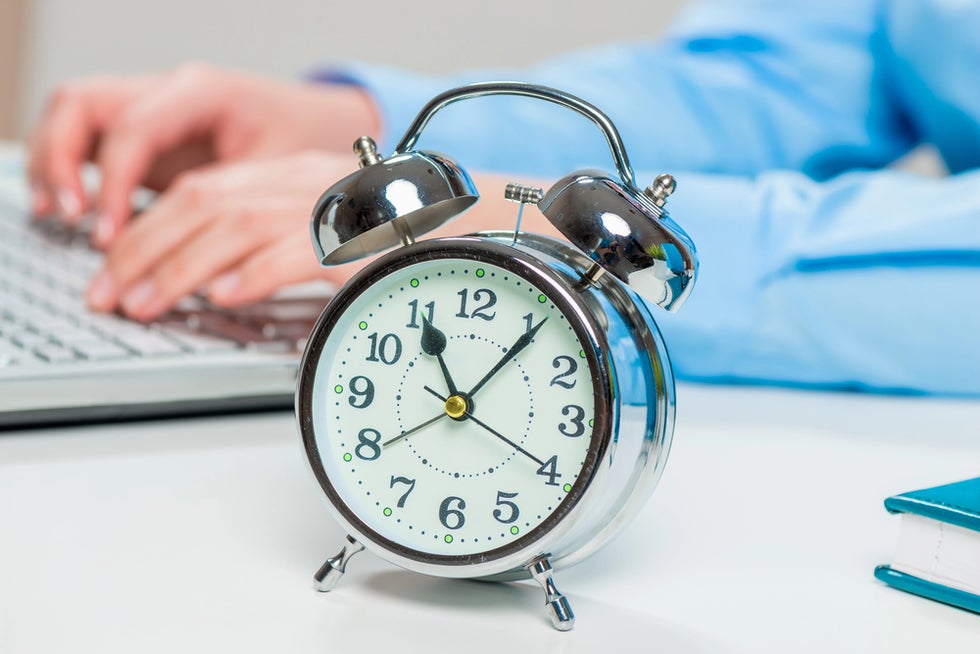 Person debating overtime exceptions next to clock