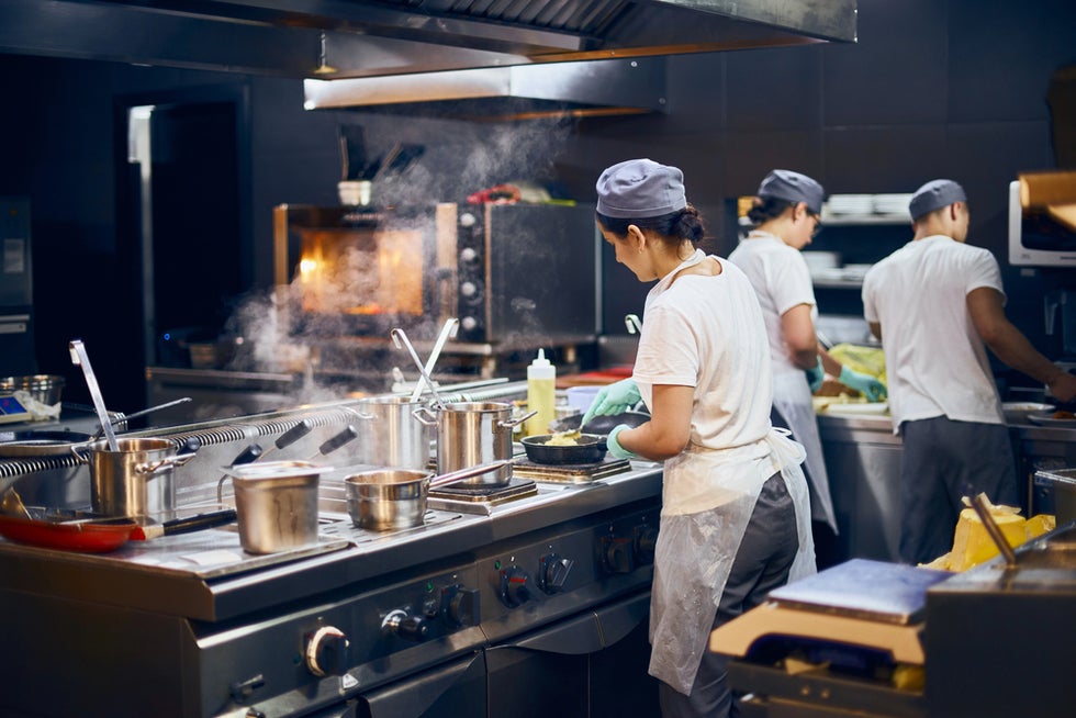 Restaurant staff members discussing unpaid wages
