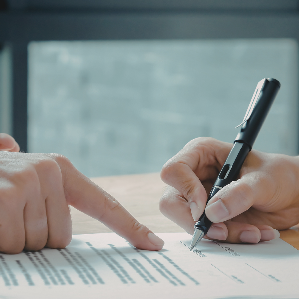Clients reviewing and signing divorce agreements and legal documents in a structured legal process