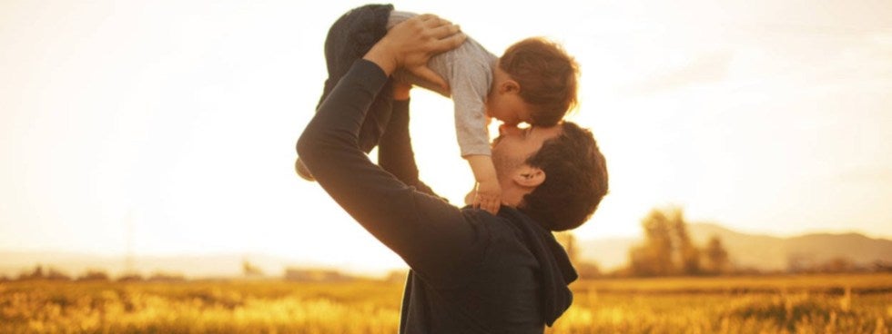 father holding son