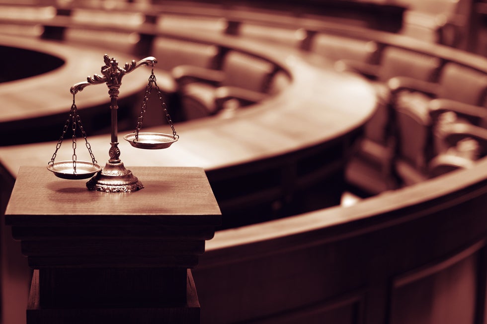 Scales of justice in an empty courtroom