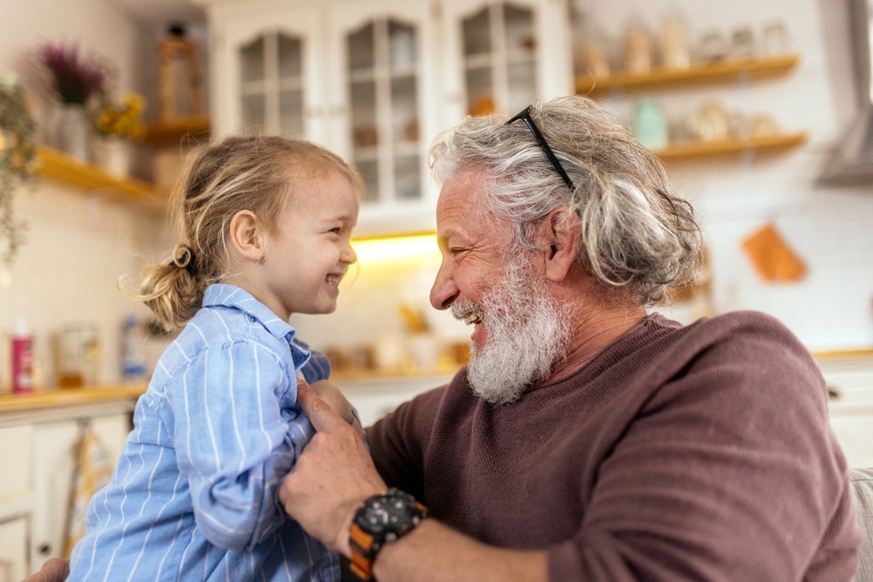 A grandpa playing with his granddaughter