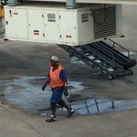 Airport Employee walking on by airplane