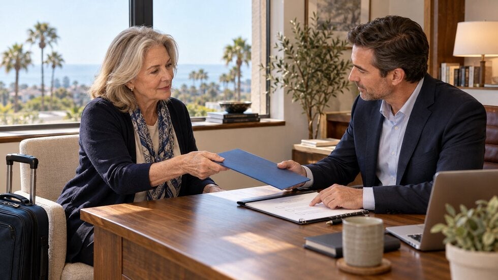 Two adults hand over a document folder during a planning meeting