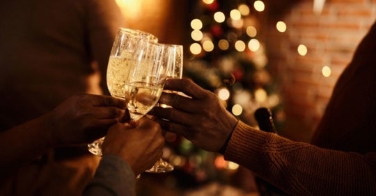 people cheersing champagne at holiday party