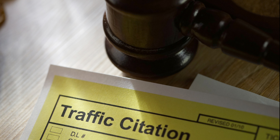 A photo of a traffic citation and a gavel.