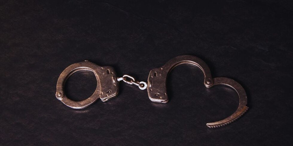 A pair of handcuffs sitting on a table.