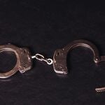 A pair of handcuffs sitting on a table.