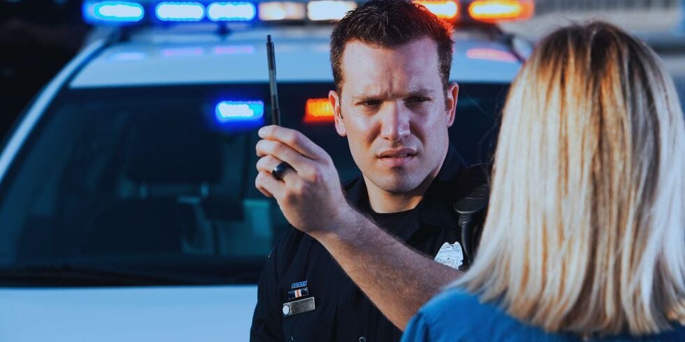 A police officer administering a field sobriety test. 