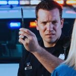 A police officer administering a field sobriety test. 