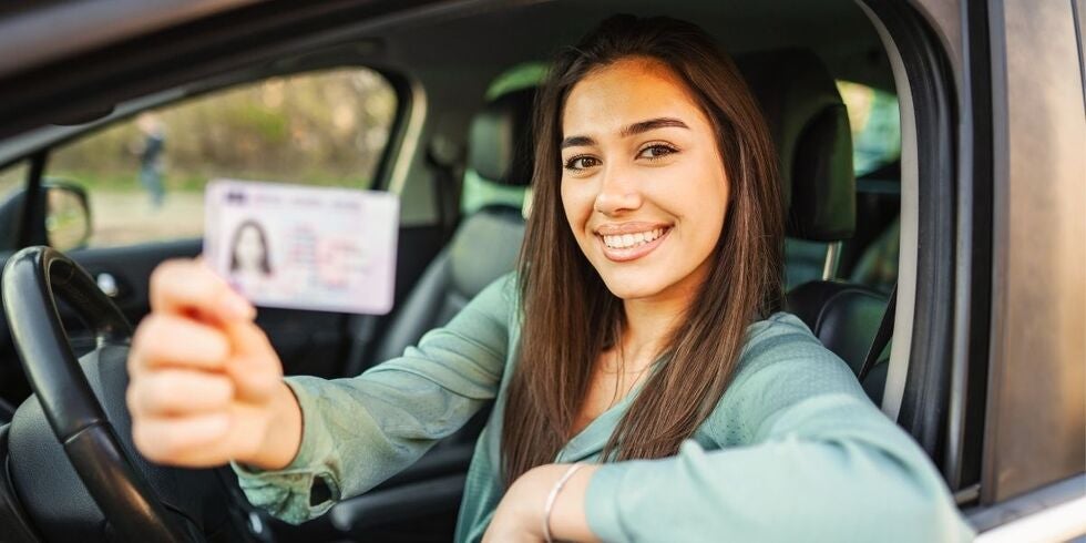 A woman happy to have a new driver's license