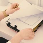 A photo of a woman looking at paper on a clipboard