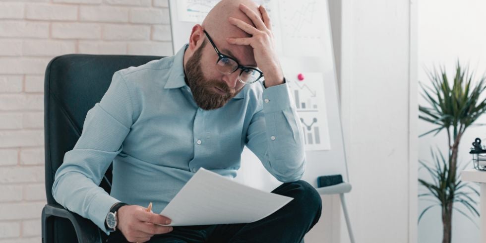 A man looking at a court notice