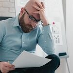 A man looking at a court notice
