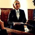 Two lawyers talking in front of a judge.