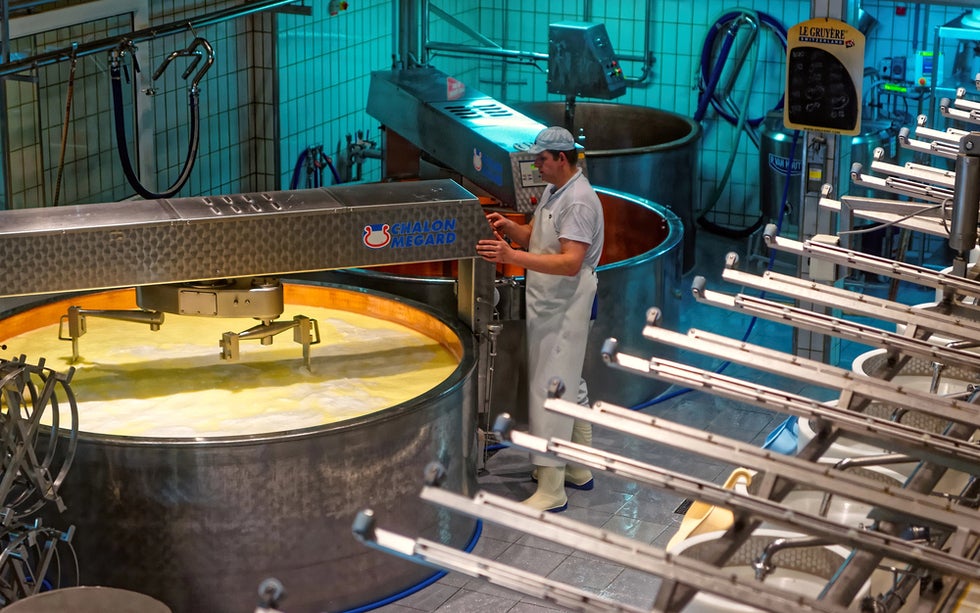 Workers using industrial kettle