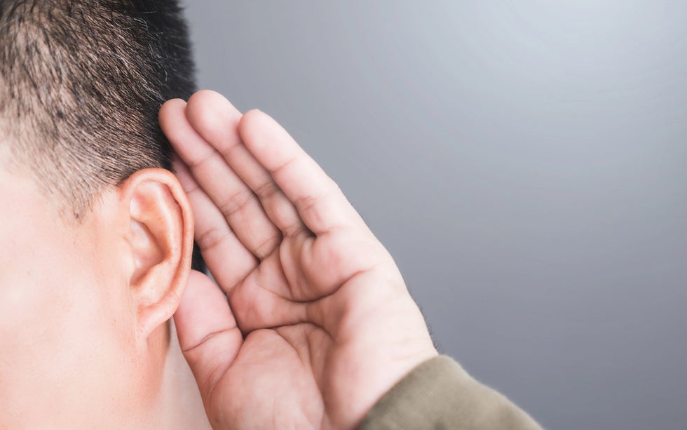 Person experiencing hearing loss at work