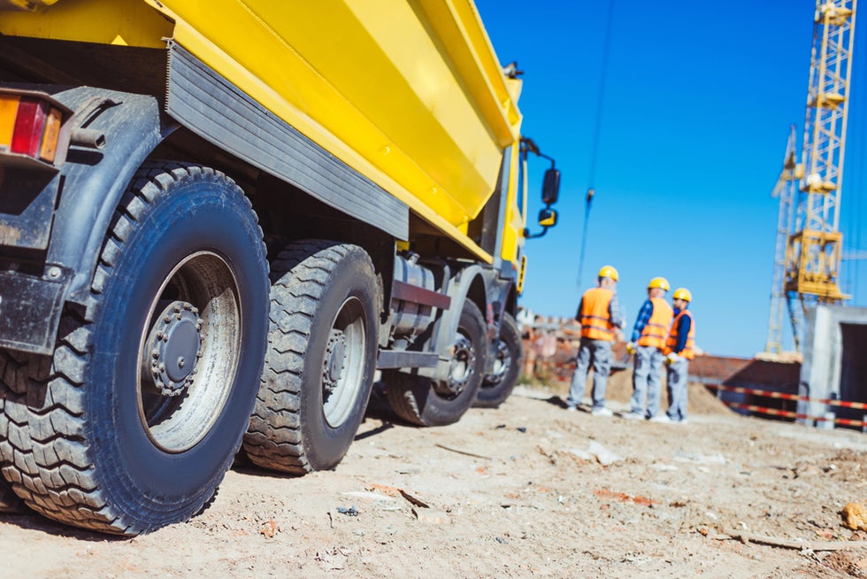 Construction subcontractors working next to truck