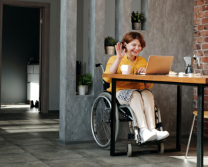 Woman in a wheel chair completes her estate plan virtually with her attorney.