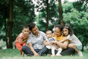 Young family in the park contemplate needing a trust