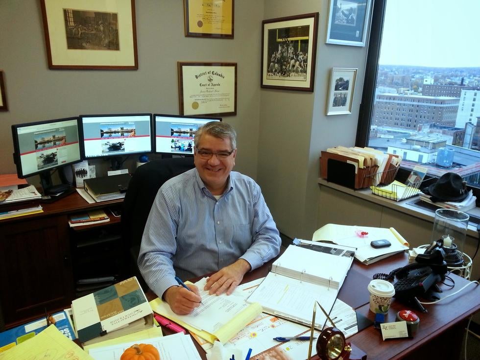 attorney Jim Miron at his desk in his Bridgeport law office