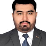 Professional headshot of Andres in a dark suit and tie, facing forward against a plain background.