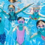 kids swimming in a swimming pool