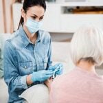 woman nursing an elderly woman during COVID-19