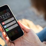 a person holding a phone with notifications - smaller image