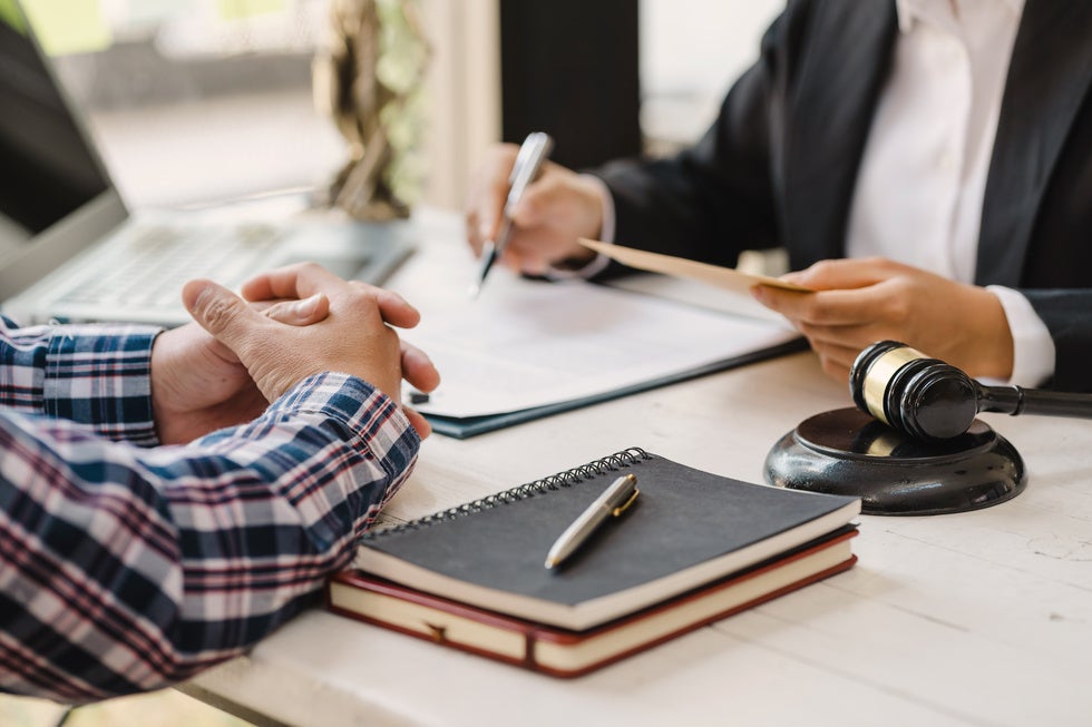 A man discussing Medicaid with an attorney