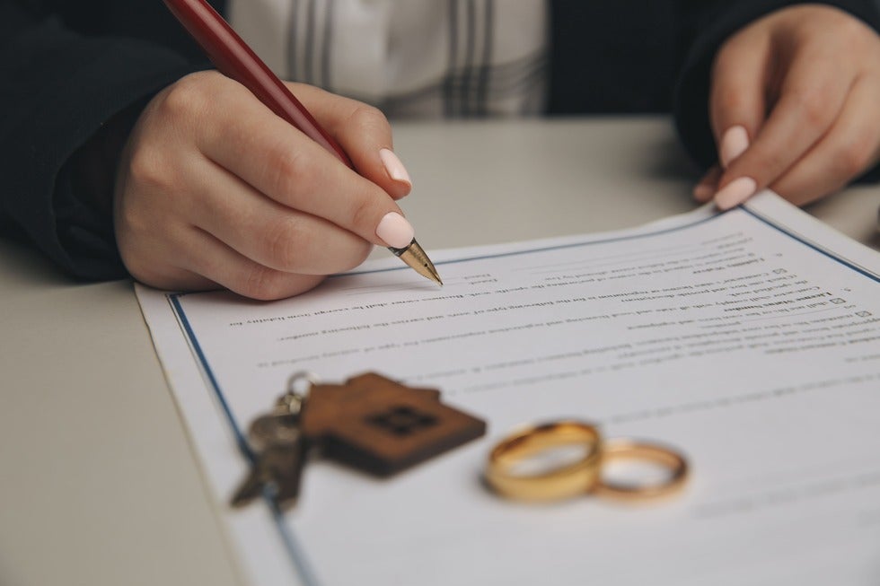 A woman and her husband finalize their divorce agreement, highlighting Family Law Services in Manasquan, New Jersey.