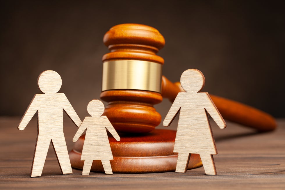Wooden family cutouts and judge's gavel representing family law services in Surf City, NJ