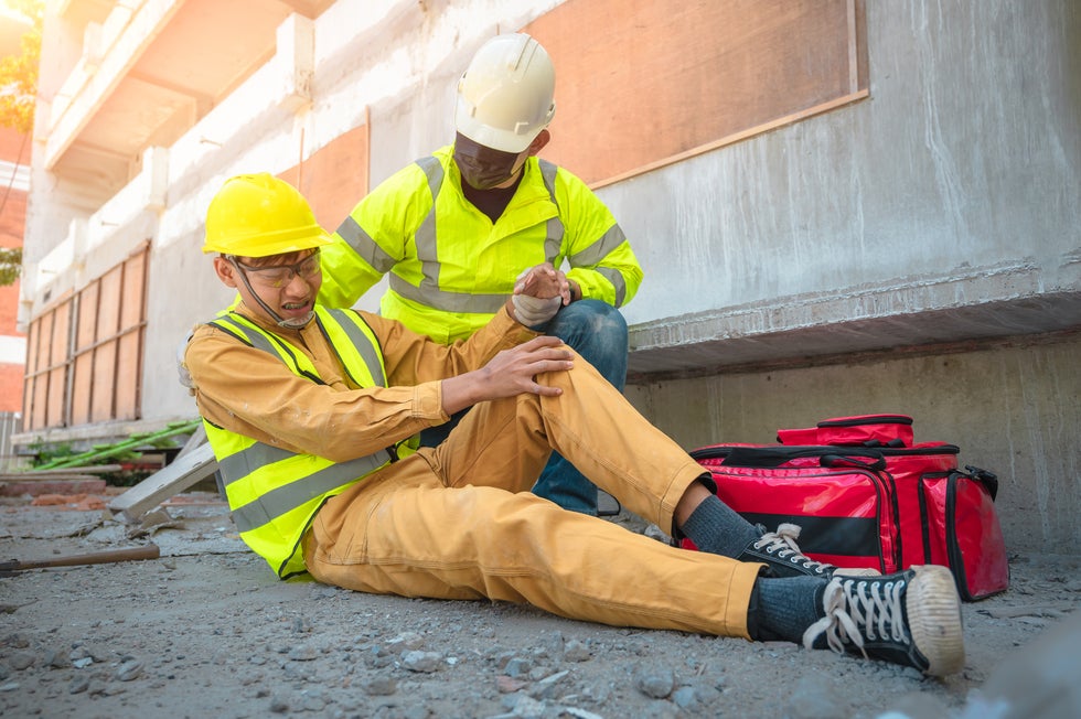 Injured construction worker receiving assistance on site, highlighting personal injury claims in Ship Bottom, NJ