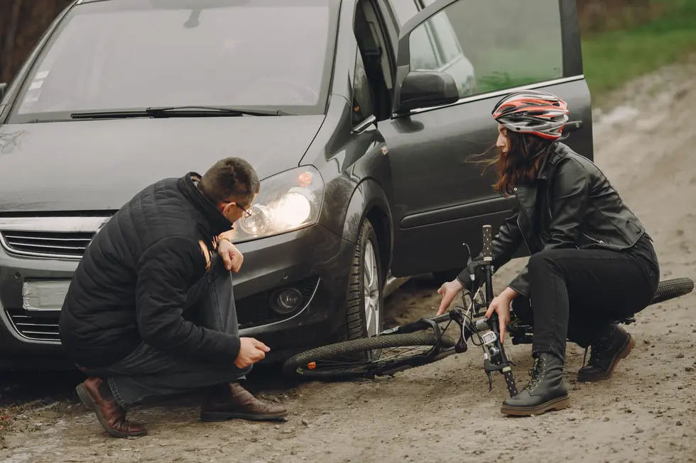 A man and woman involved in car crash with a car, highlighting the aftermath of a bicycle accident in New Jersey.