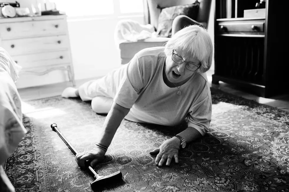 An elderly woman on the floor with a crane, suggesting a recent slip and fall incident related to renters insurance issues.