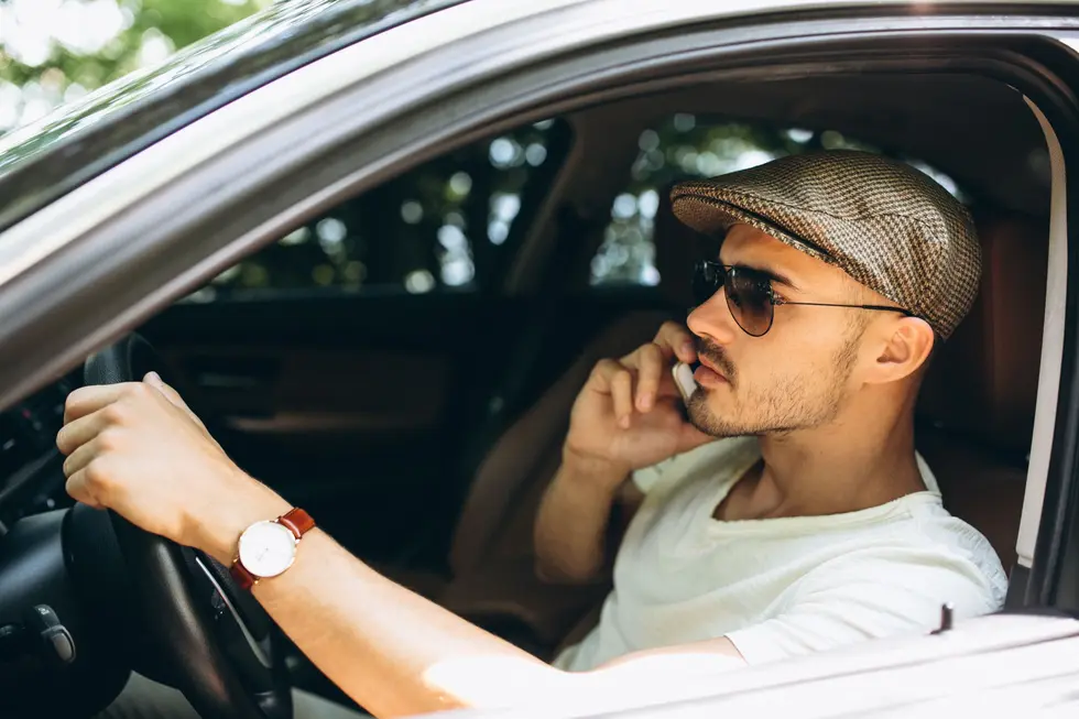 Out-of-state driver talking on the phone inside a vehicle before driving in New Jersey