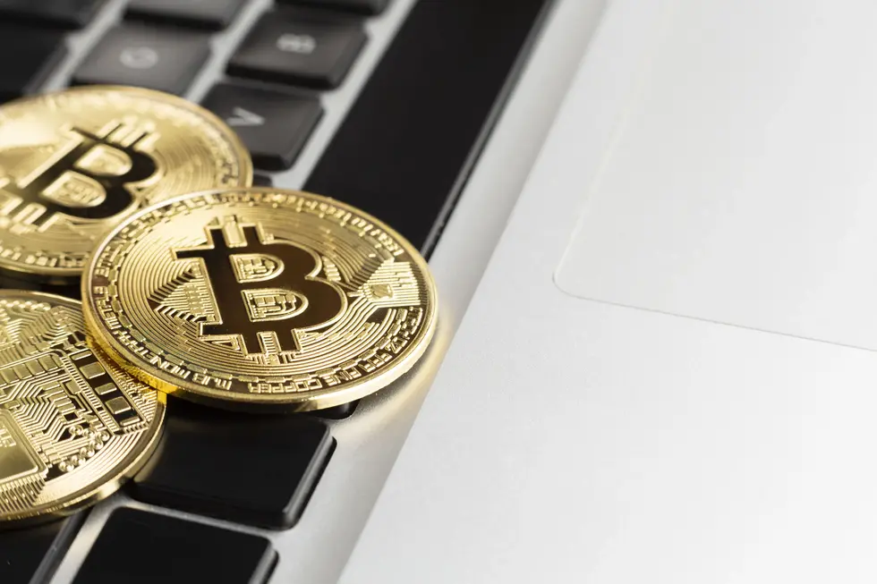 Close-up of Bitcoin coins on laptop keyboard representing digital evidence and financial investigations in DWI-related cases