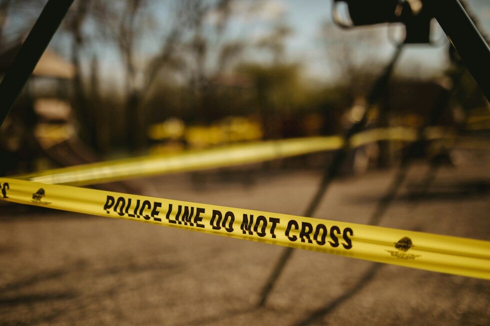 Yellow police line tape at a crime scene, representing violent crimes defense in New Jersey