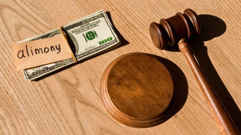 A gavel, money, and a note stating alimony.