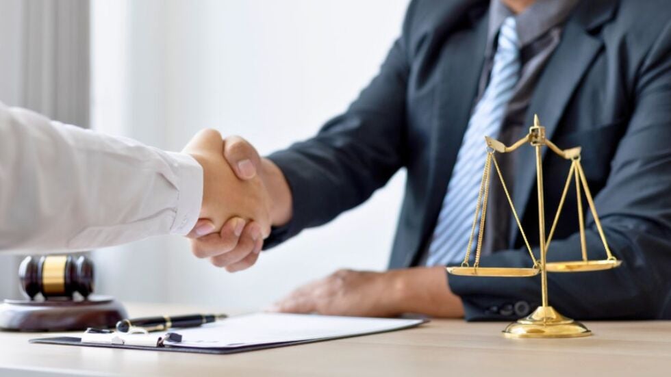 Florida family law attorney shaking hands with a client after their discussion on attorney’s fees and costs of litigation.
