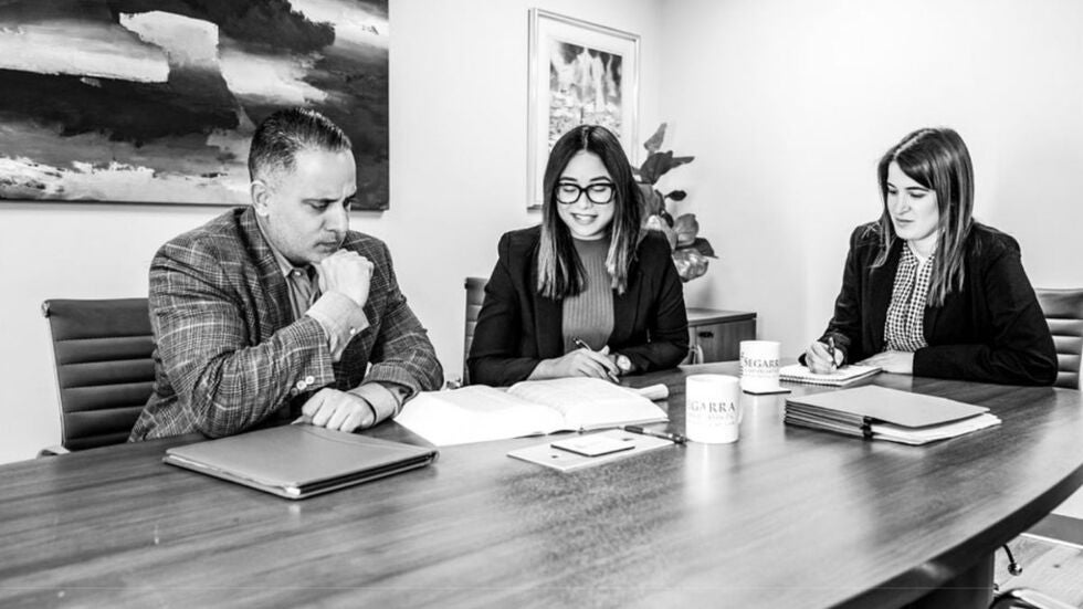 The legal team of Segarra & Associates, P.A., discussing a domestic violence case.