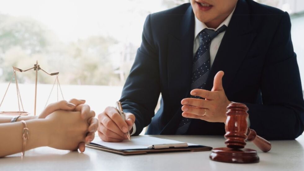 A lawyer and client engaged in a discussion about case enforcement strategies.