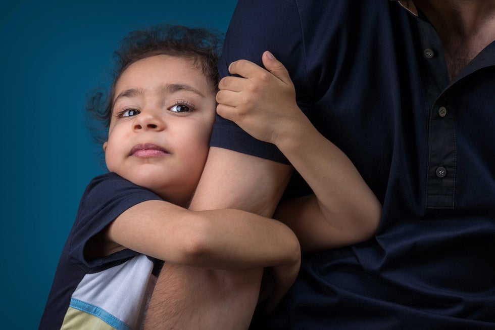 Child holding onto father