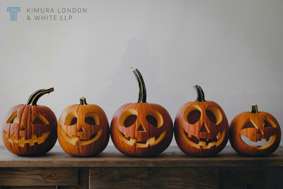 Carved pumpkins lined up next to each other.