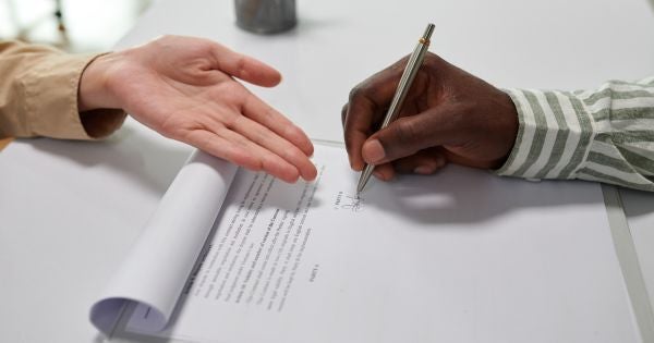 contract law lawyer signing paper