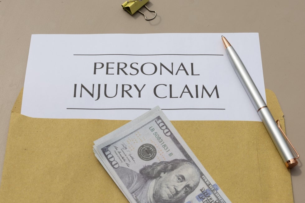 Personal injury claim document with settlement money representing case value in Englewood Cliffs New Jersey