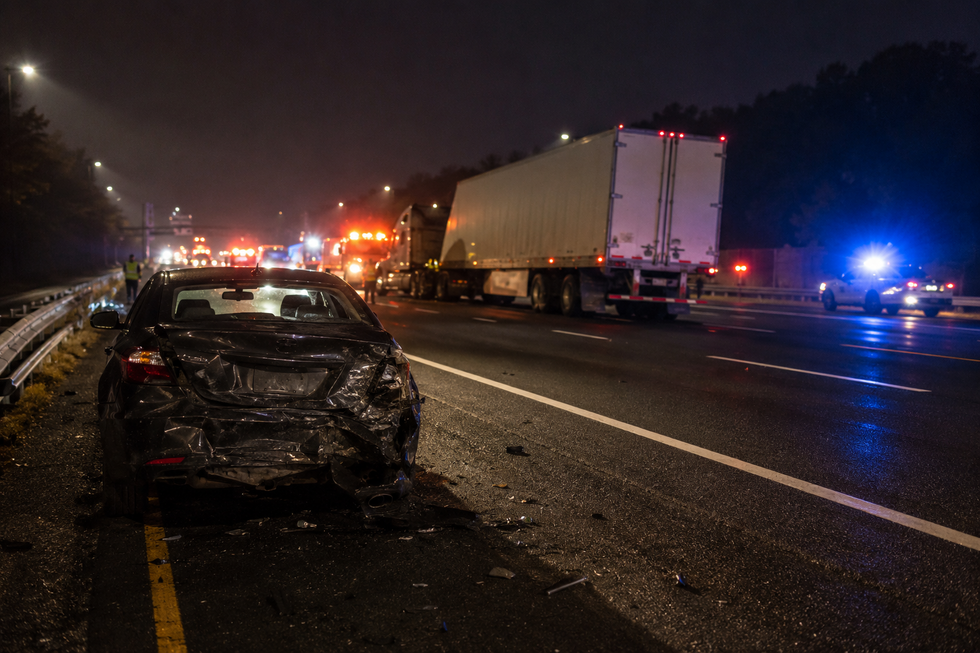 Emergency response scene following a tractor-trailer rear-end collision on the New Jersey Turnpike involving multiple vehicles.
